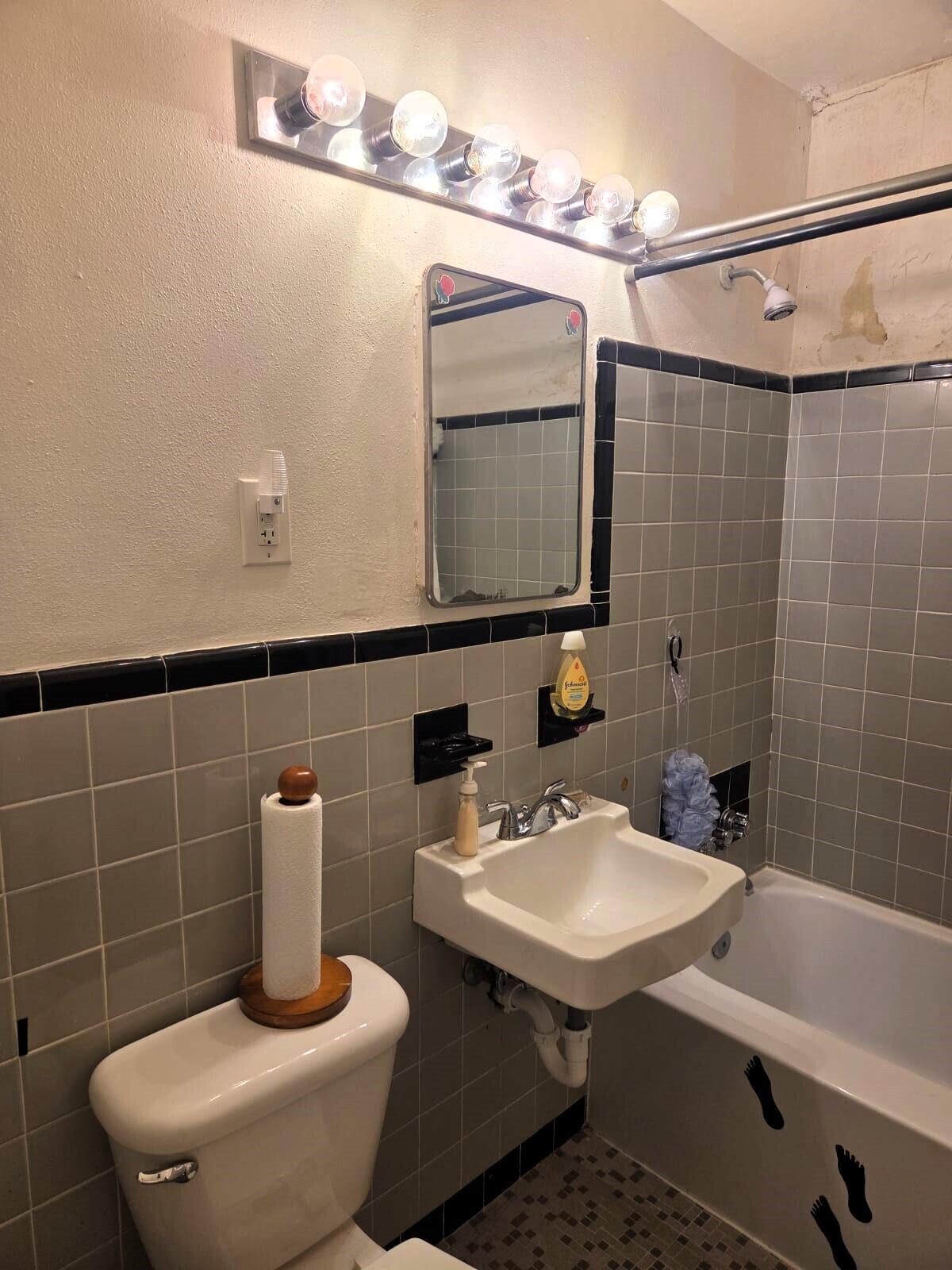 1060 West 26th Court Riviera Beach, FL 33404 - Photo 15 of 23 a bathroom with a sink toilet and shower