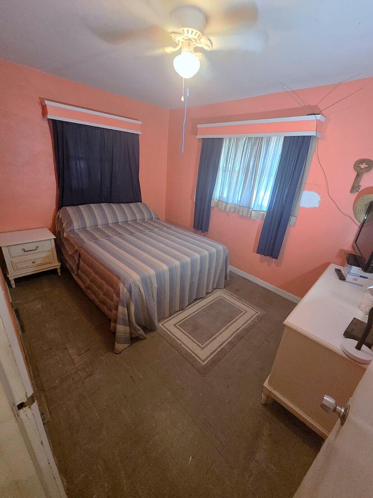 1060 West 26th Court Riviera Beach, FL 33404 - Photo 16 of 23 a bedroom with a bed and window