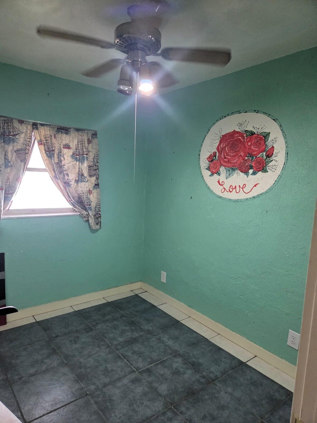 1060 West 26th Court Riviera Beach, FL 33404 - Photo 18 of 23 a room with a fan and a window