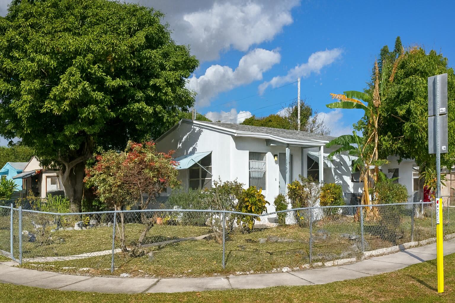 1060 West 26th Court Riviera Beach, FL 33404 - Photo 20 of 23 a view of a house with swimming pool