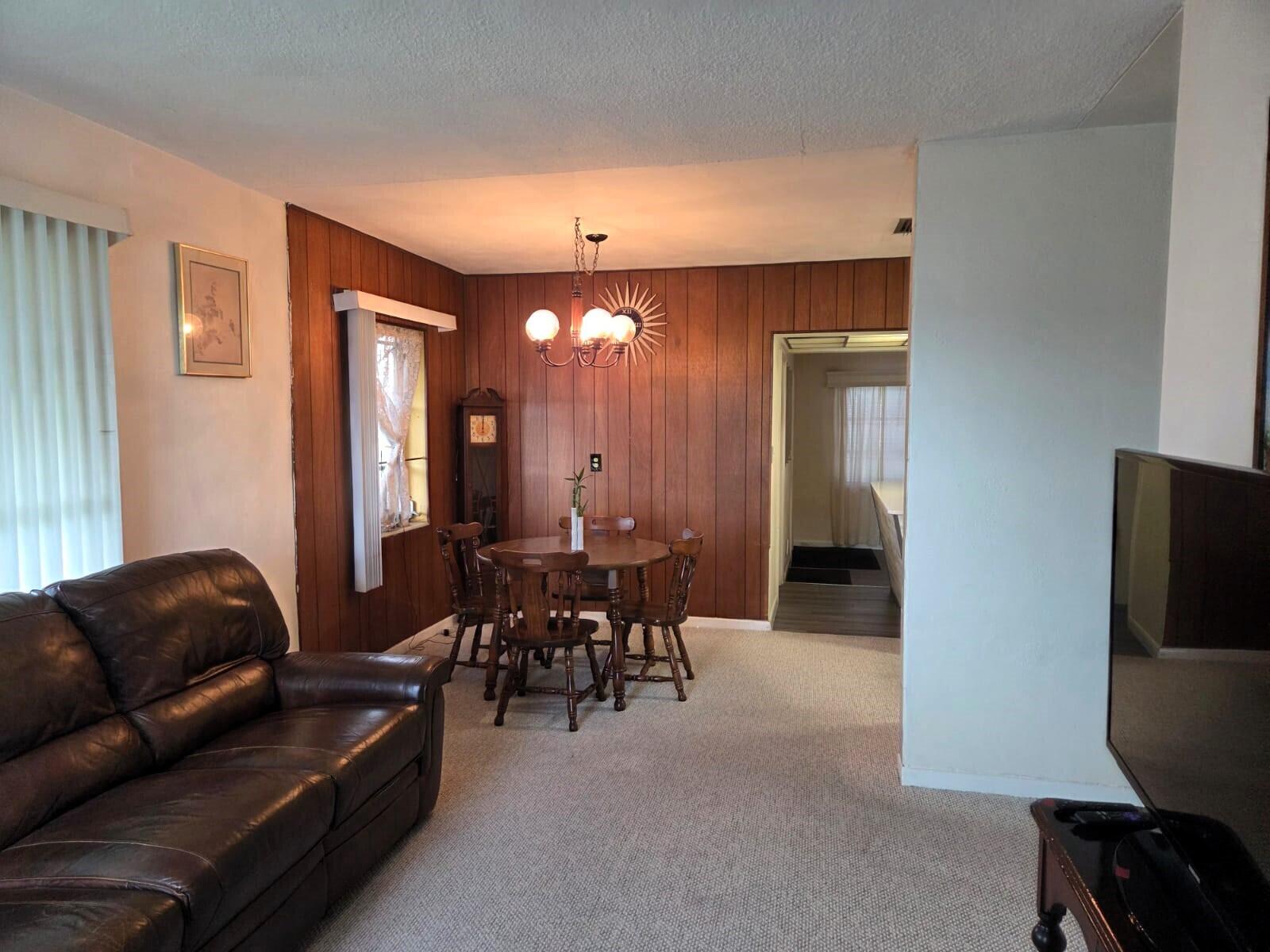 1060 West 26th Court Riviera Beach, FL 33404 - Photo 5 of 23 a living room with furniture a dining table and a refrigerator