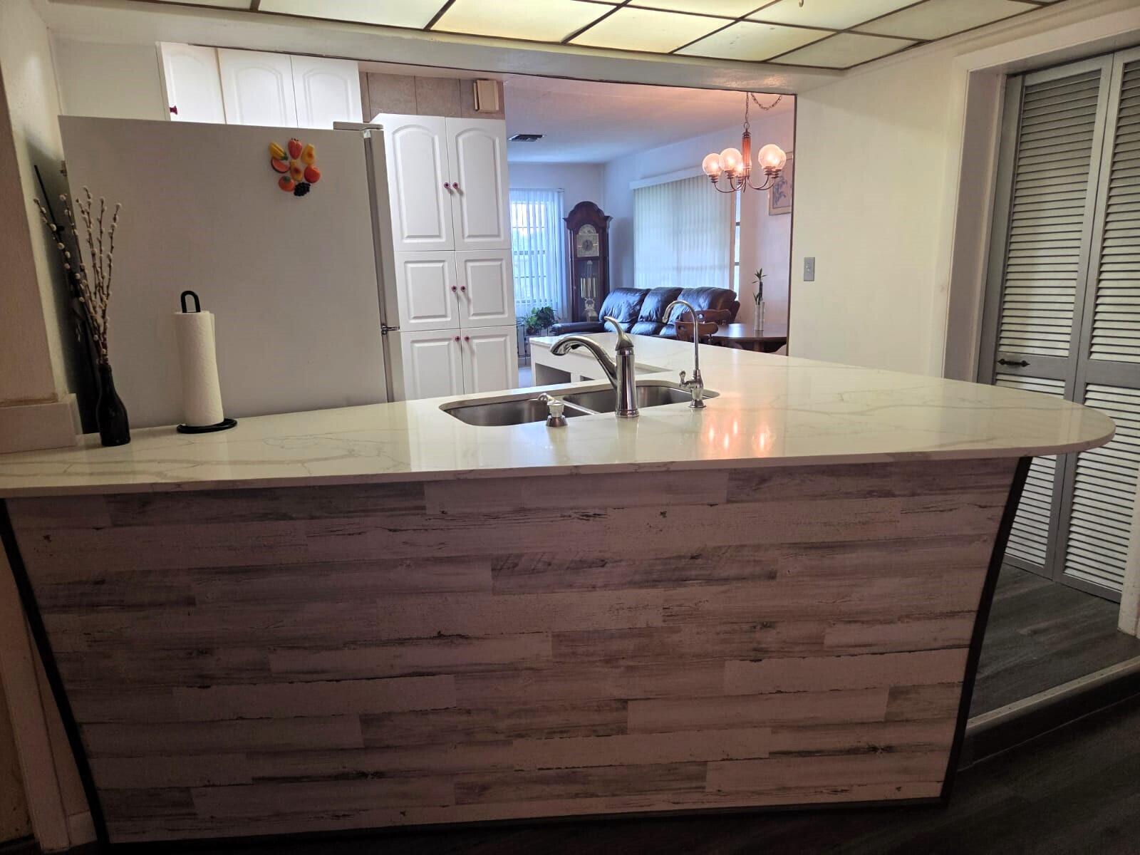 1060 West 26th Court Riviera Beach, FL 33404 - Photo 6 of 23 a bathroom with a granite countertop sink and a mirror