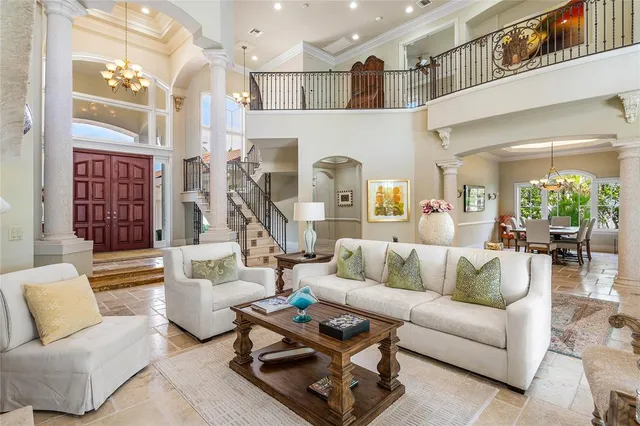 a living room with furniture and a view of kitchen