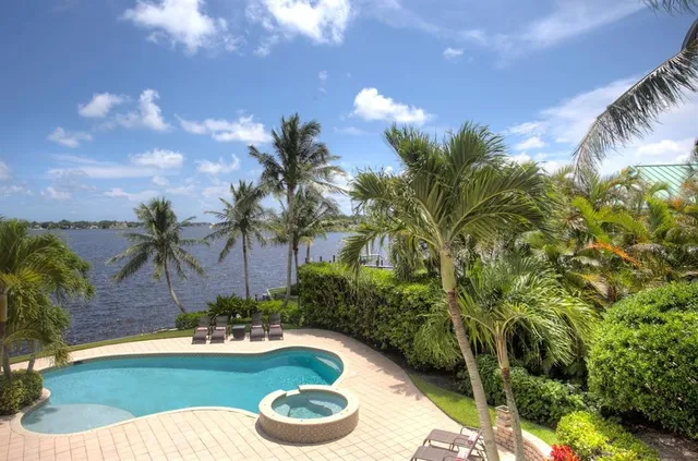 a front view of a house with swimming pool having outdoor seating