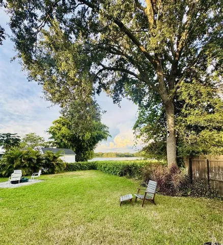 a backyard of a house with table and chairs