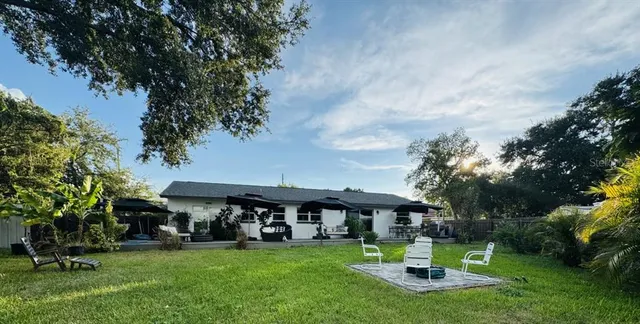 a view of a house with a yard porch and sitting area