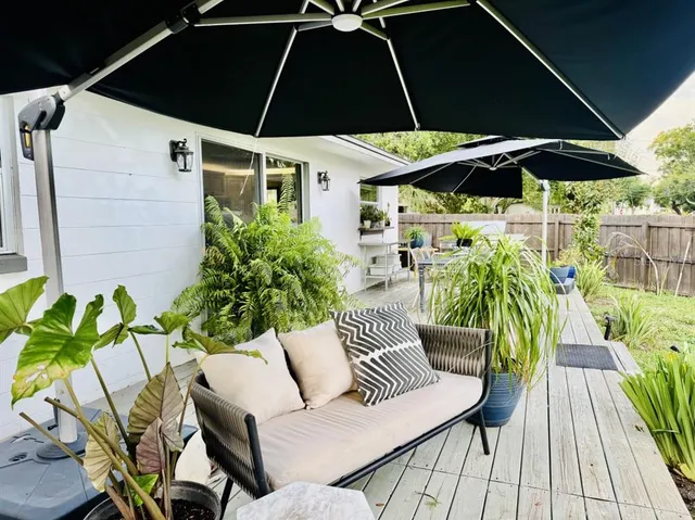 a view of an outdoor sitting area with furniture and umbrella