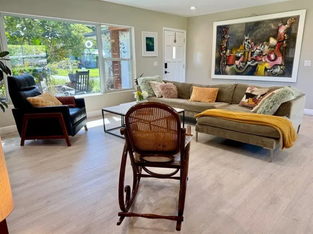 a living room with furniture and a large window