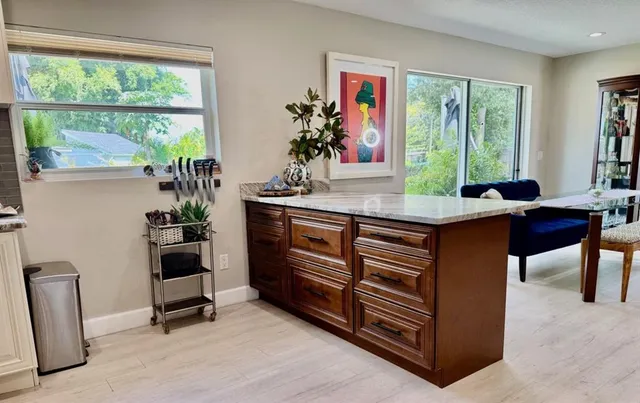a view of a workspace with furniture and a window