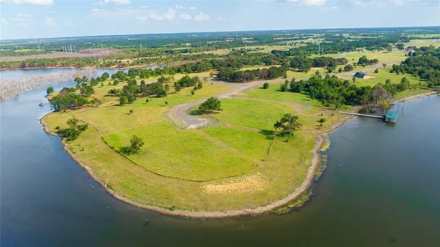 a view of a swimming pool with a table chairs