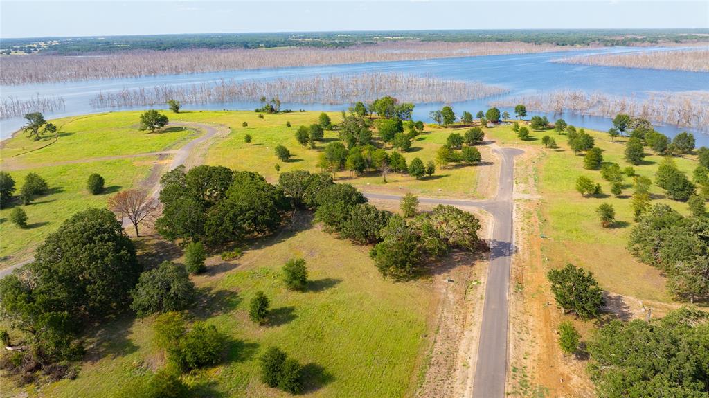 Lot 95 Water Edge Way Bonham, TX 75418 - Photo 9 of 21 a view of a swimming pool with a lawn chairs and swimming pool