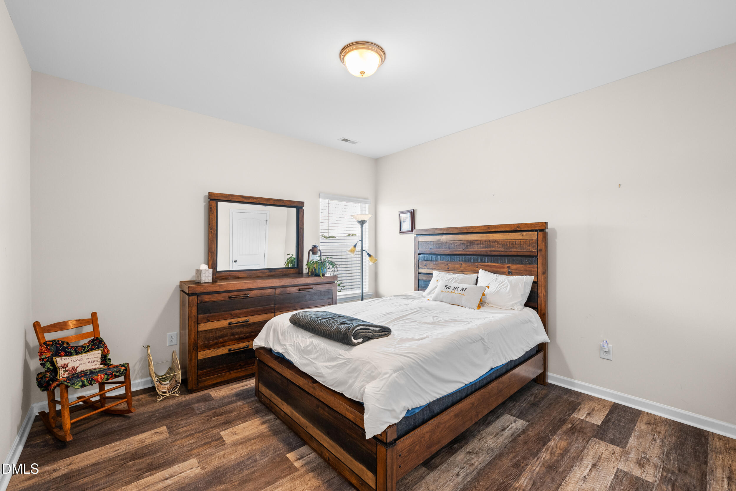 91 Charlottes Web Circle Benson, NC 27504 - Photo 18 of 29 a bedroom with a bed and wooden floor