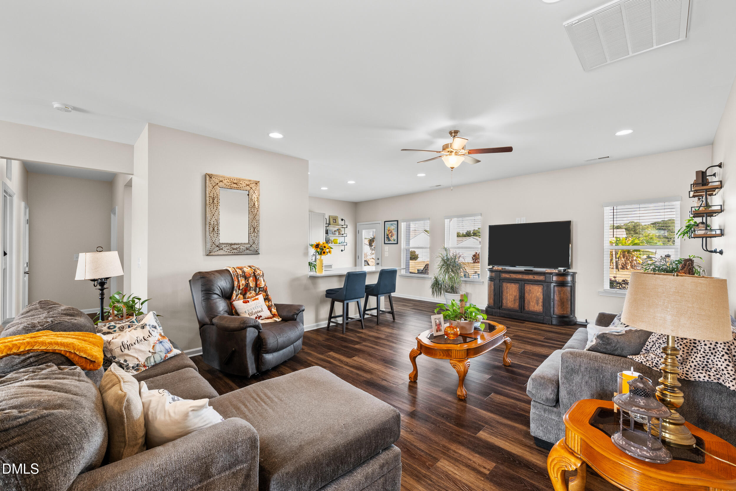 91 Charlottes Web Circle Benson, NC 27504 - Photo 8 of 29 a living room with furniture a flat screen tv and a fireplace