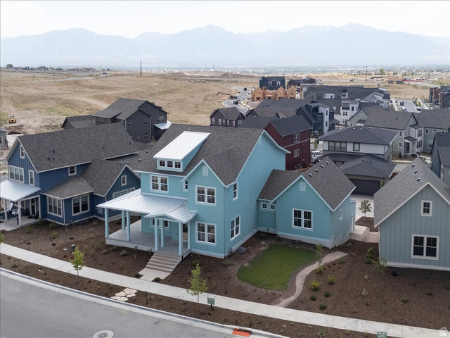 7189 South Sage Road, Unit 214 West Jordan, UT 84081 - Photo 4 of 29 Turquoise residence featuring a prominent metal roof dormer and a covered front porch