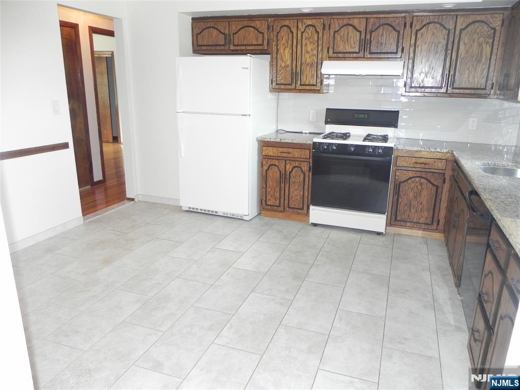 52 Wilson Street, Unit 2 Little Ferry, NJ 07643 - Photo 4 of 11 a kitchen with a stove top oven and cabinets
