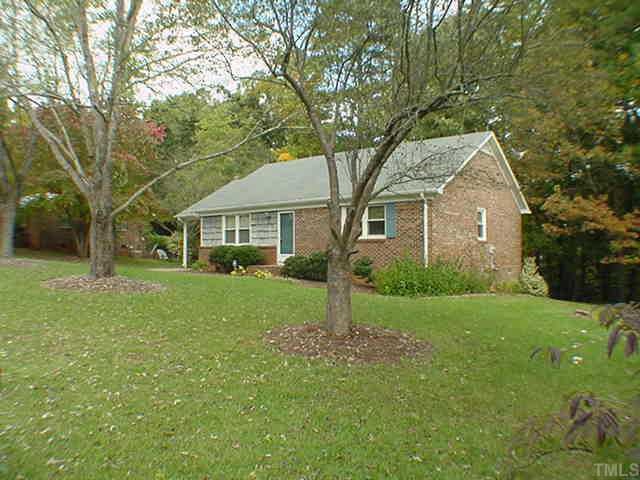 7533 Stuart Drive Raleigh, NC 27615 - Photo 1 of 1 a front view of a house with a yard and trees