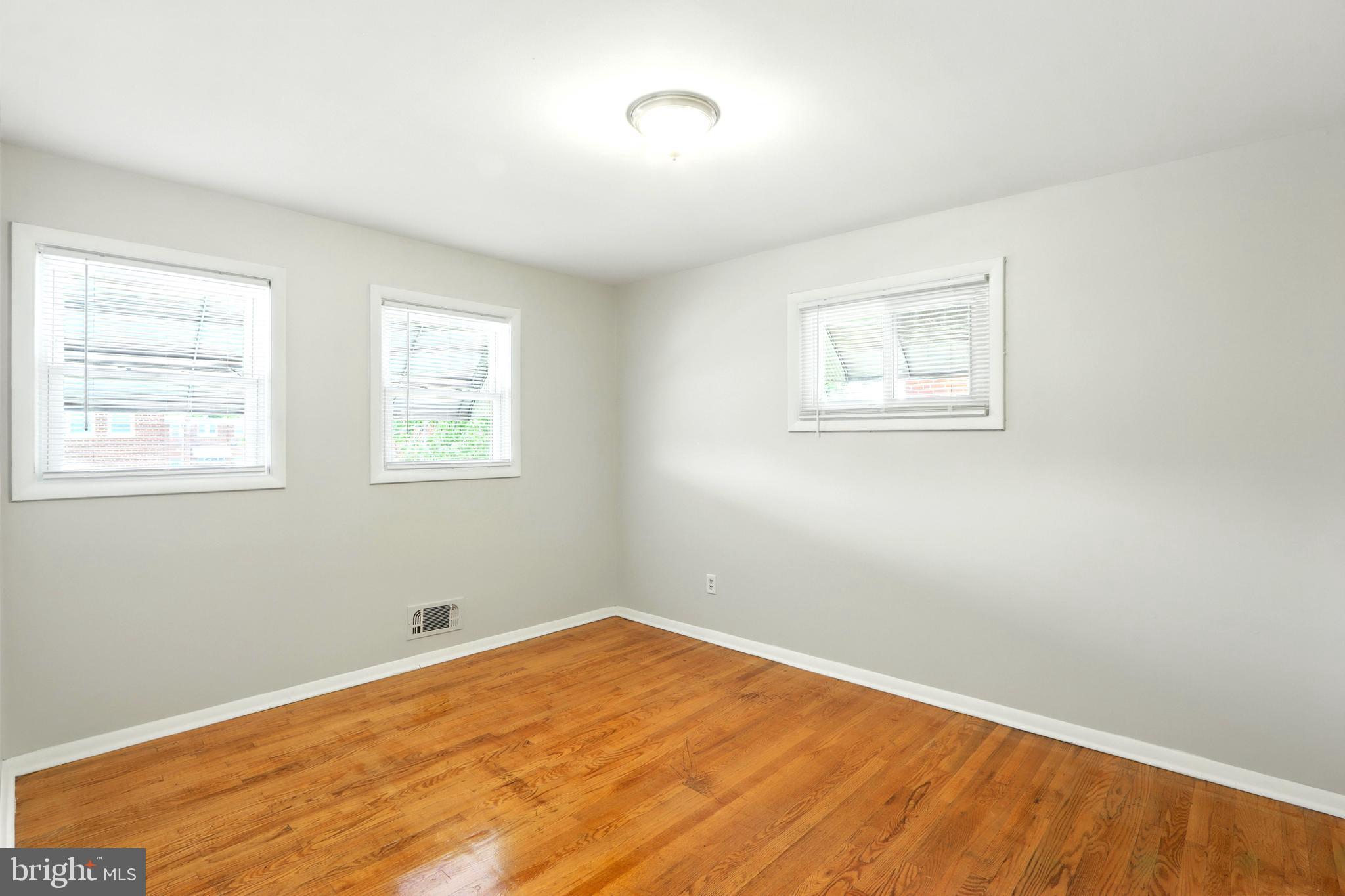 4255 Labyrinth Road Baltimore, MD 21215 - Photo 15 of 27 a view of a room with wooden floor and windows