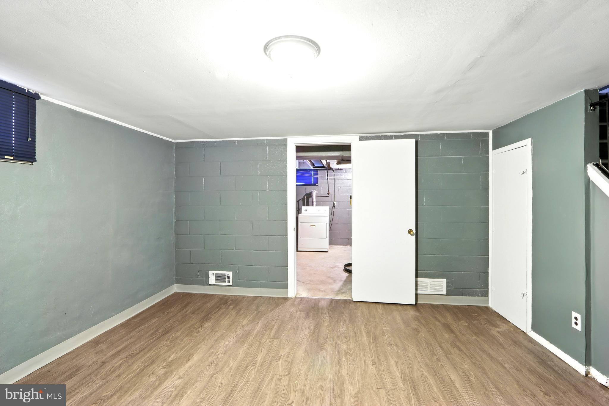 4255 Labyrinth Road Baltimore, MD 21215 - Photo 21 of 27 a view of an empty room with closet and wooden floor