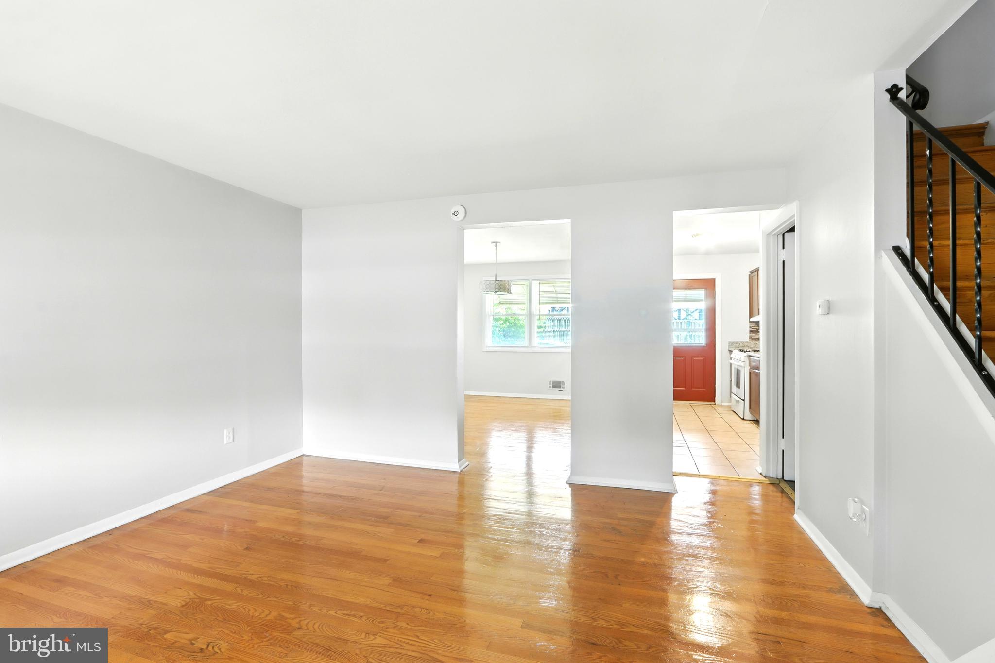 4255 Labyrinth Road Baltimore, MD 21215 - Photo 3 of 27 a view of an empty room with wooden floor and a window
