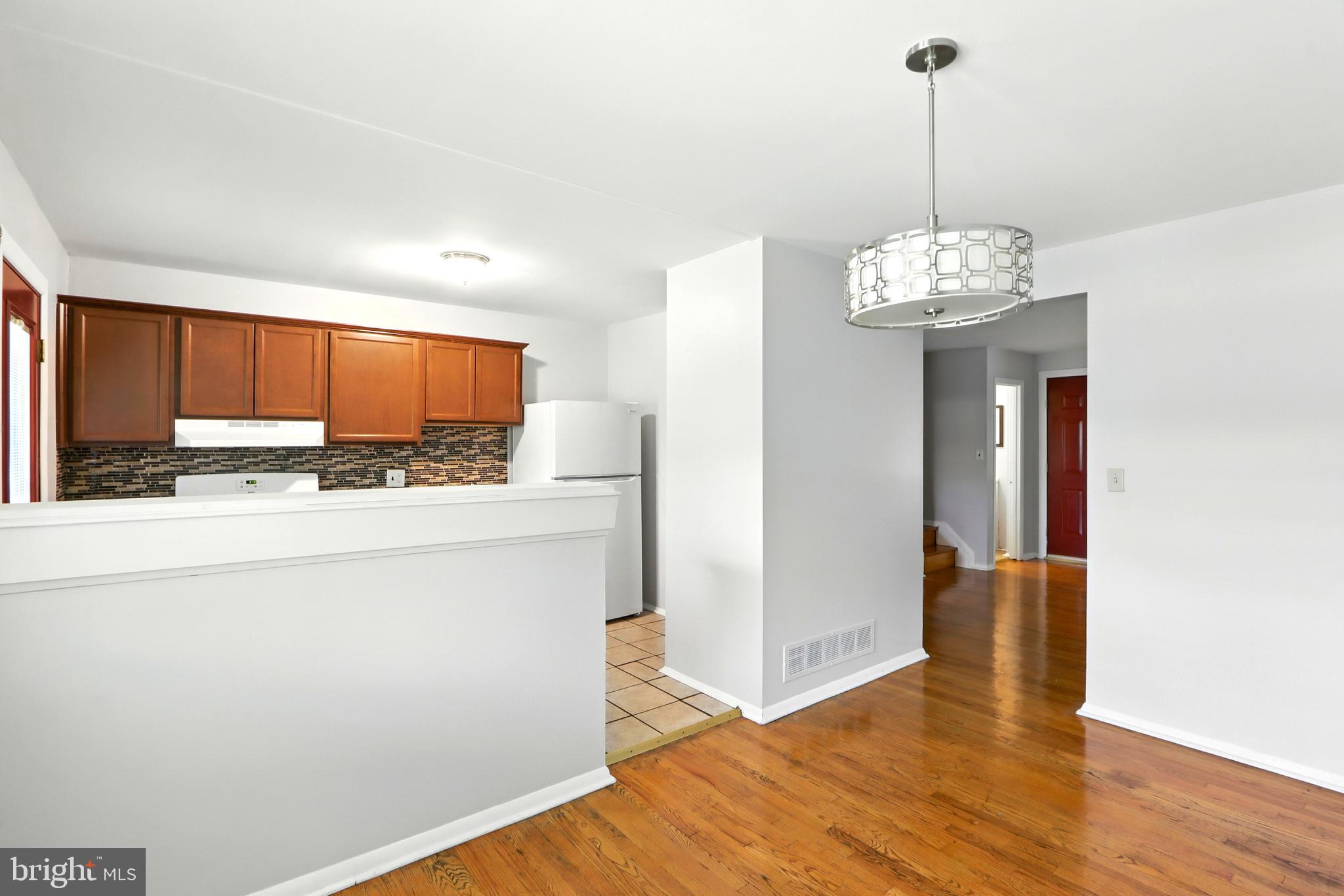 4255 Labyrinth Road Baltimore, MD 21215 - Photo 6 of 27 a kitchen with stainless steel appliances granite countertop a refrigerator and a stove top oven