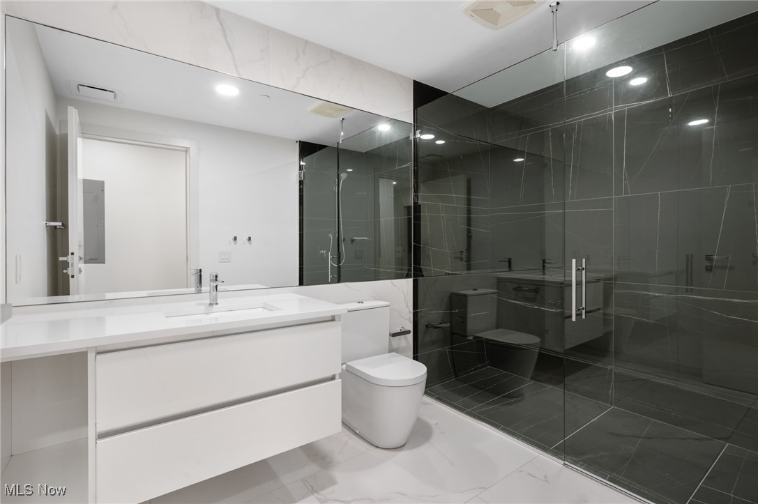 22700 Lake Road, Unit 204 Rocky River, OH 44116 - Photo 24 of 31 Full bathroom with vanity, a shower stall, light marble finish flooring, and recessed lighting