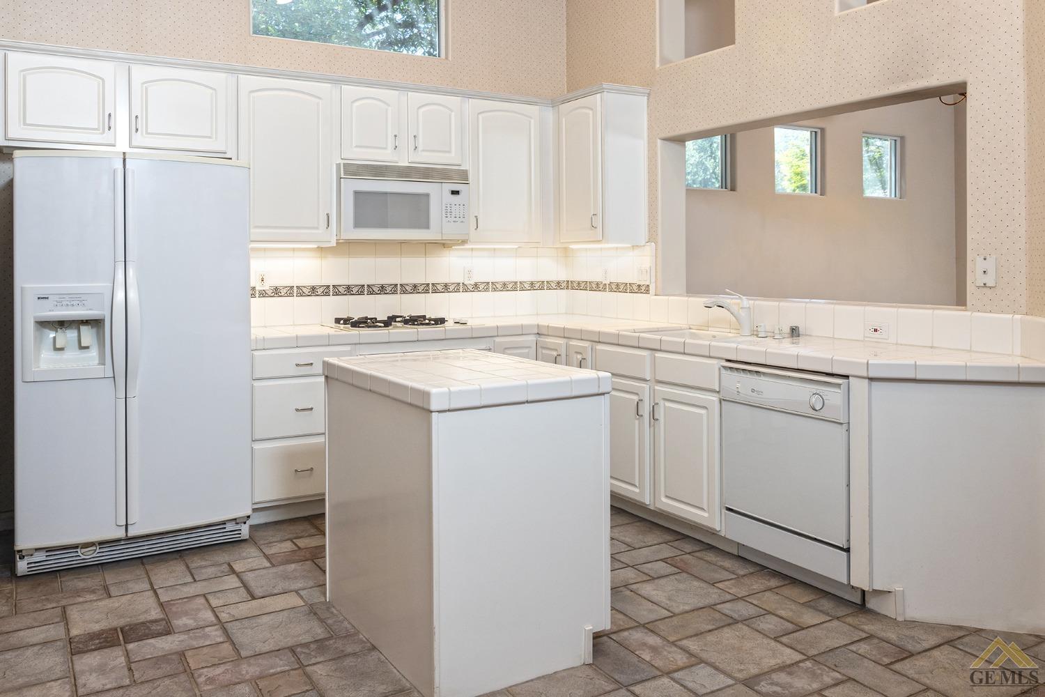 Undisclosed Address Bakersfield, CA 93311 - Photo 14 of 31 a kitchen with a stove sink and cabinets