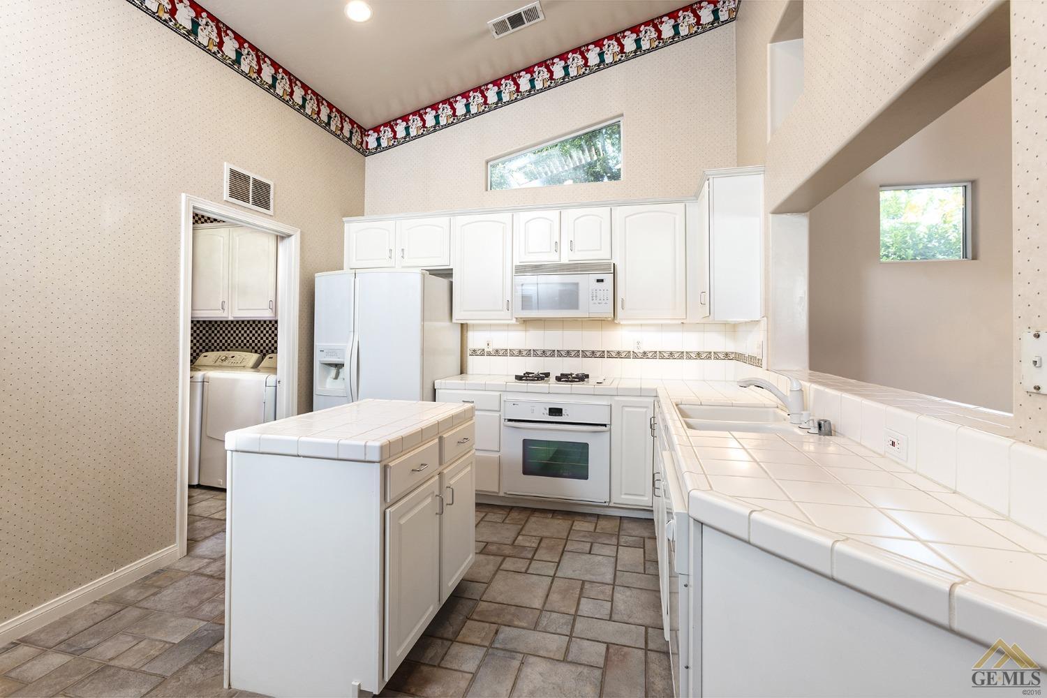 Undisclosed Address Bakersfield, CA 93311 - Photo 16 of 31 a kitchen with a sink stove and refrigerator