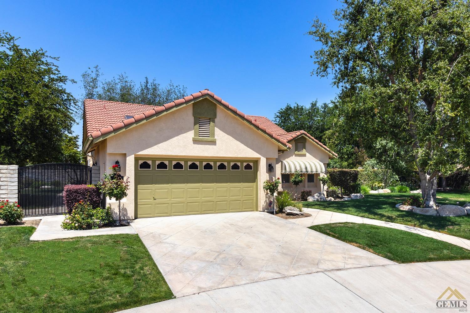 Undisclosed Address Bakersfield, CA 93311 - Photo 2 of 31 a front view of a house with a yard and garage