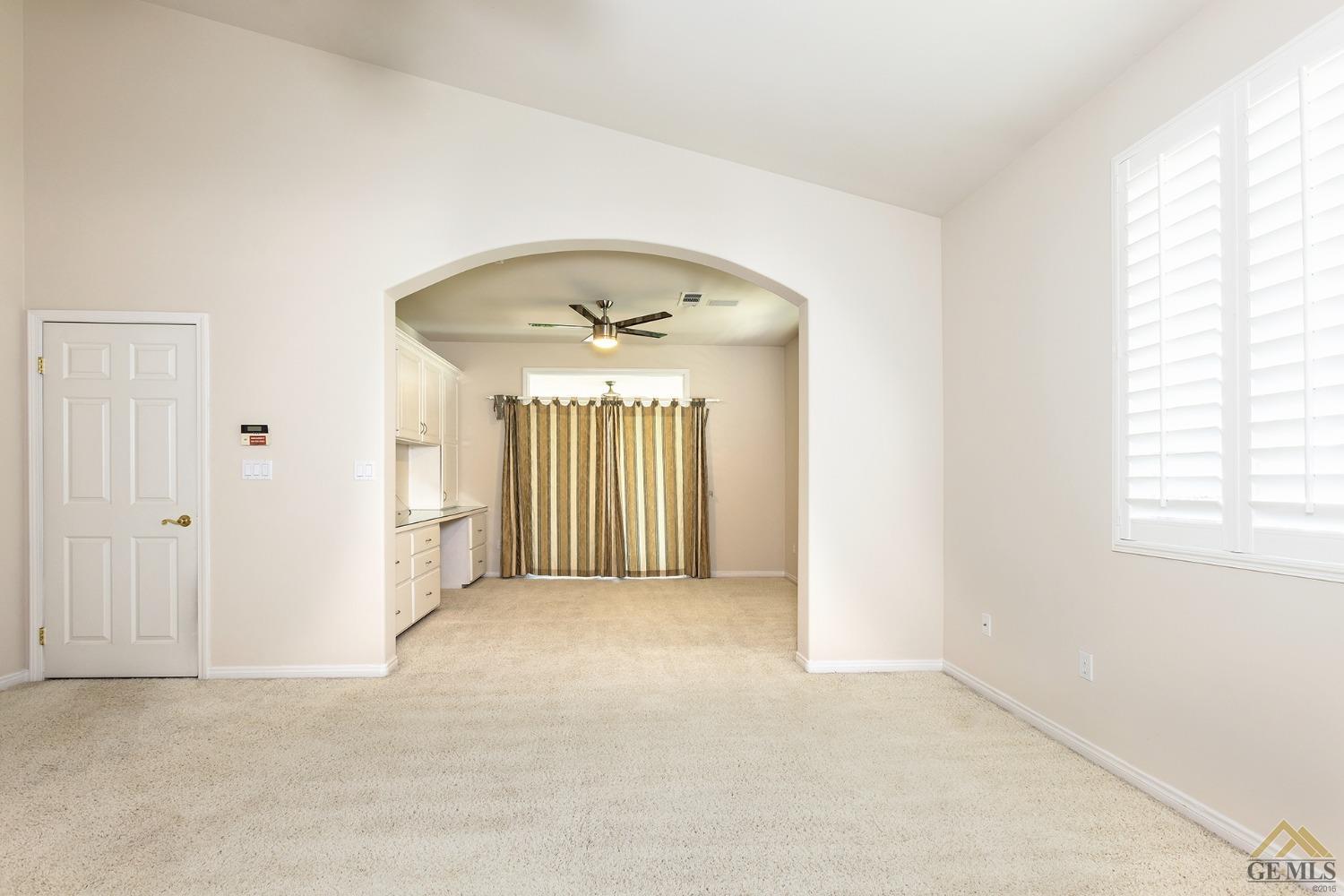 Undisclosed Address Bakersfield, CA 93311 - Photo 25 of 31 an empty room with chandelier fan and windows