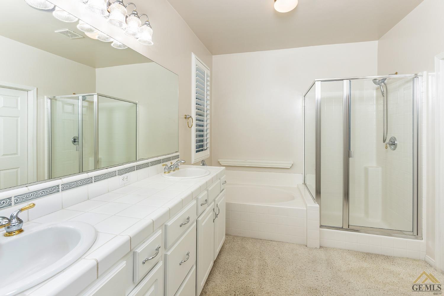 Undisclosed Address Bakersfield, CA 93311 - Photo 27 of 31 a bathroom with a tub sink and mirror