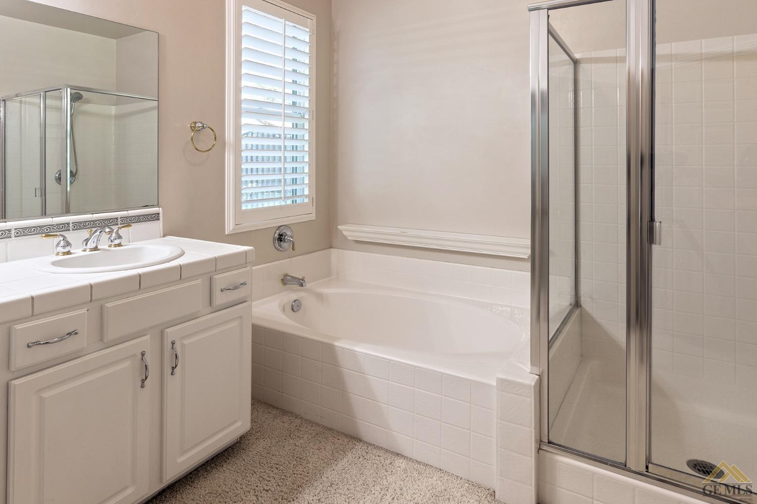 Undisclosed Address Bakersfield, CA 93311 - Photo 28 of 31 a bathroom with a tub sink and a mirror
