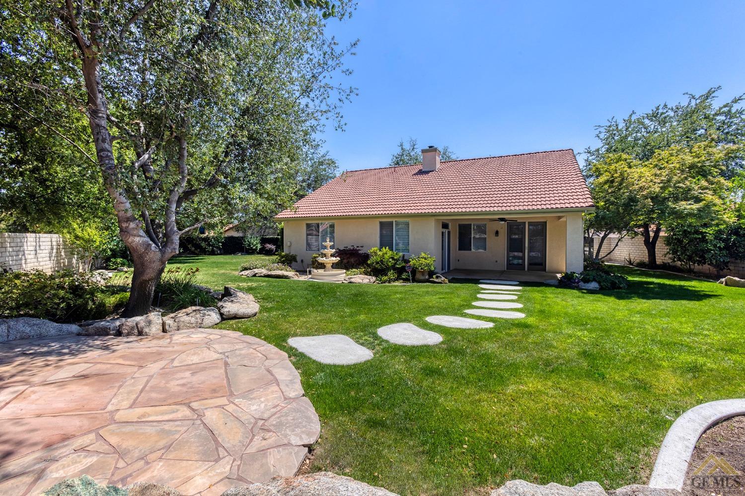 Undisclosed Address Bakersfield, CA 93311 - Photo 7 of 31 a front view of a house with a yard table and chairs