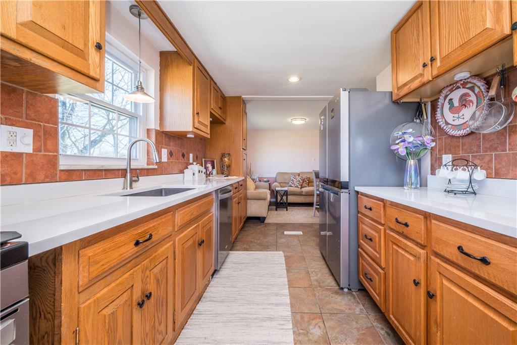 4915 Brownsville Road Pittsburgh, PA 15236 - Photo 8 of 21 a large kitchen with stainless steel appliances lots of counter space and a sink