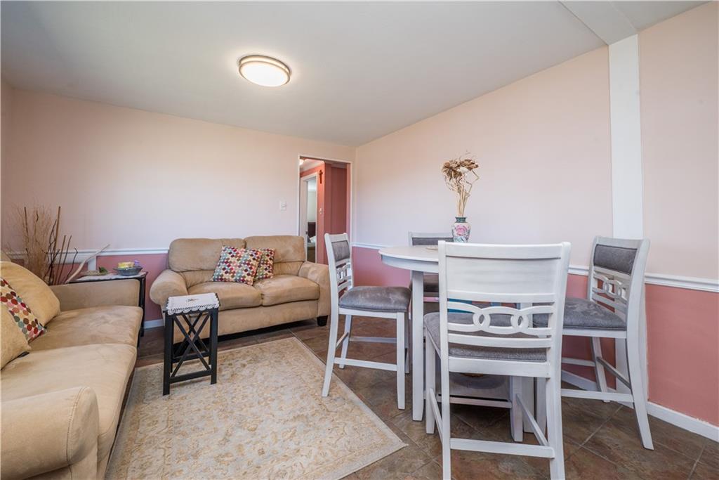 4915 Brownsville Road Pittsburgh, PA 15236 - Photo 10 of 21 a living room with furniture a flat screen tv and a table