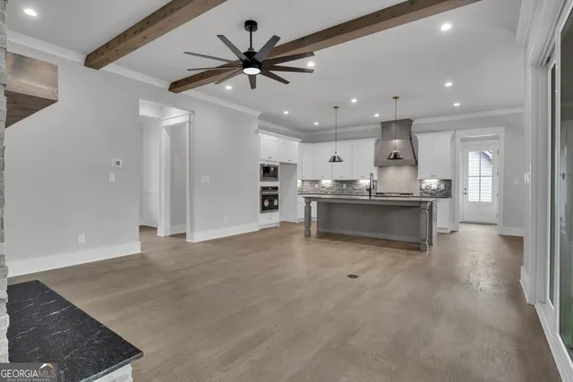 a kitchen with stainless steel appliances granite countertop a sink a stove and a refrigerator