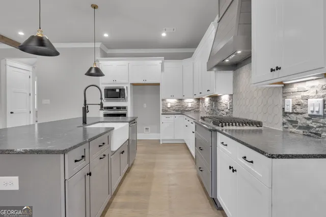 a view of kitchen with refrigerator and window