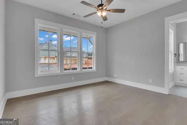 a bathroom with a granite countertop toilet sink and mirror