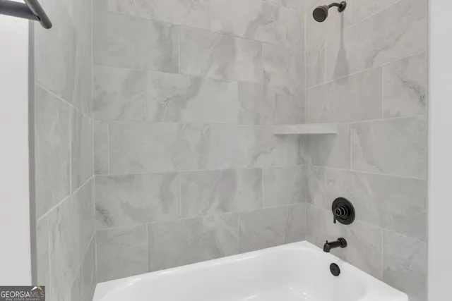 a spacious bathroom with a double vanity sink a mirror and a shower