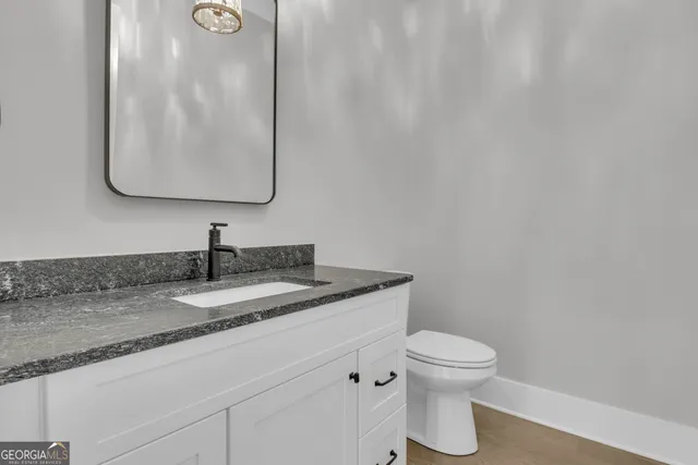 a spacious bathroom with a shower sink and mirror