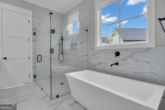 a view of staircase with railing and white walls