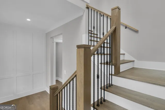 a view of a room with a stylish ceiling fan and entryway