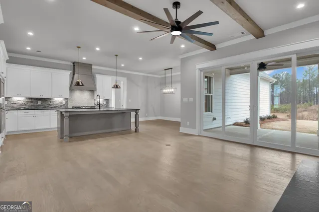 a kitchen with stainless steel appliances granite countertop a sink a stove and a refrigerator