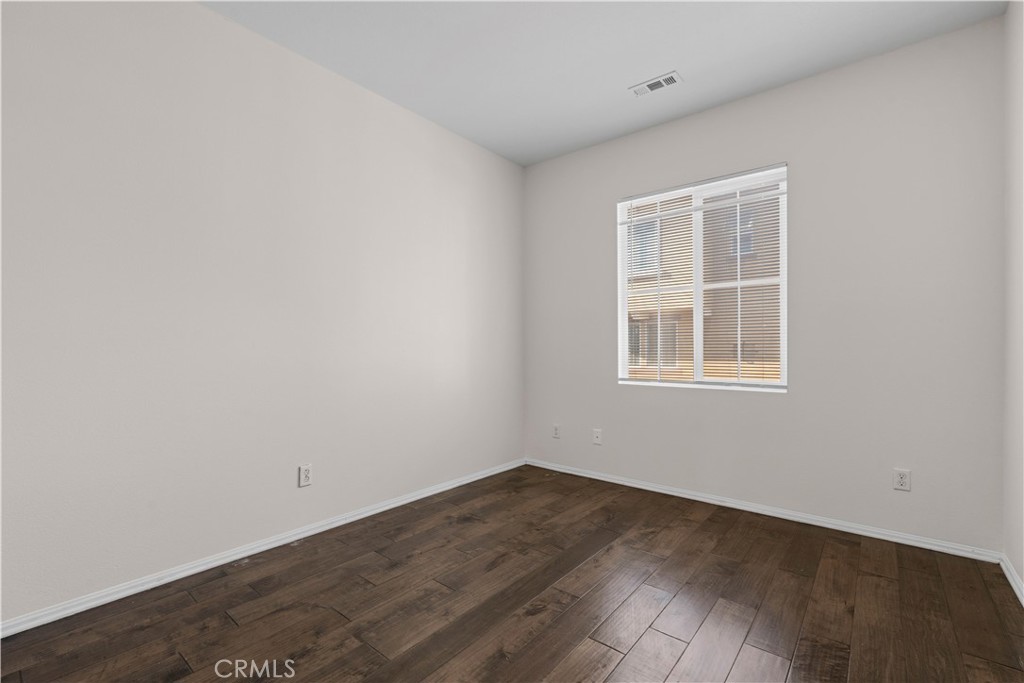 8039 City View Place Rancho Cucamonga, CA 91730 - Photo 11 of 39 an empty room with wooden floor and windows