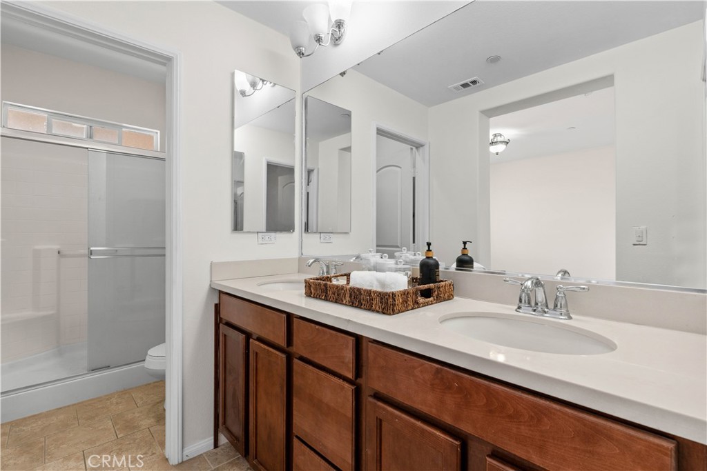 8039 City View Place Rancho Cucamonga, CA 91730 - Photo 17 of 39 a bathroom with double sink and a mirror