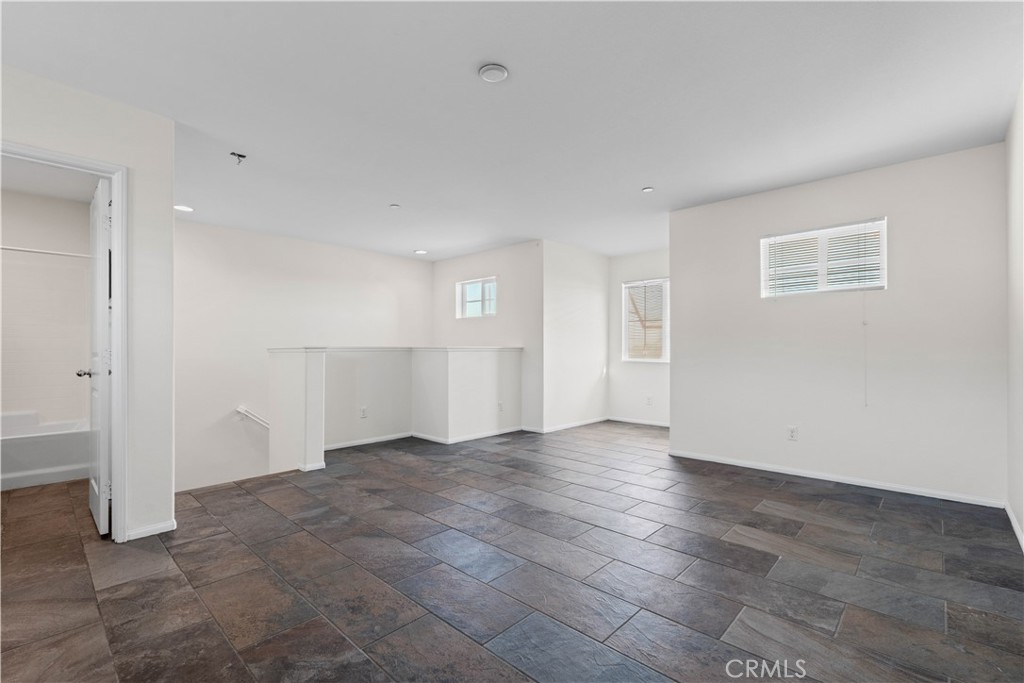 8039 City View Place Rancho Cucamonga, CA 91730 - Photo 24 of 39 an empty room with entrance and kitchen