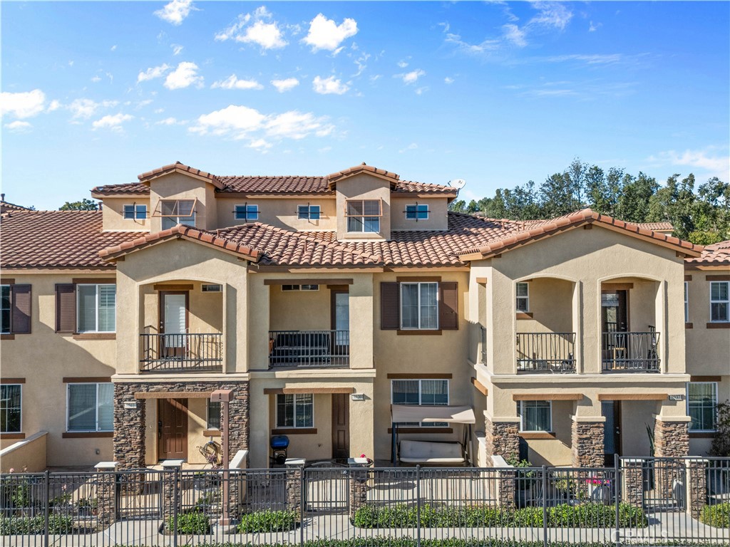 8039 City View Place Rancho Cucamonga, CA 91730 - Photo 31 of 39 a front view of a residential apartment building with a yard