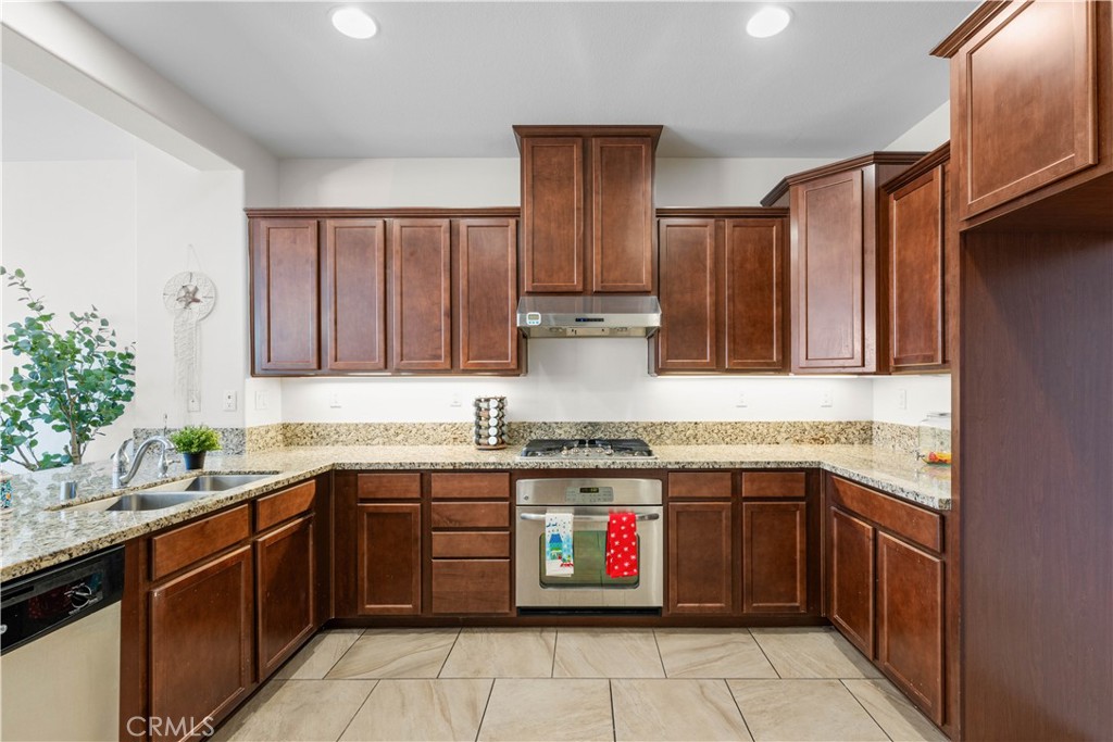 8039 City View Place Rancho Cucamonga, CA 91730 - Photo 5 of 39 a kitchen with a sink stove top oven and cabinets