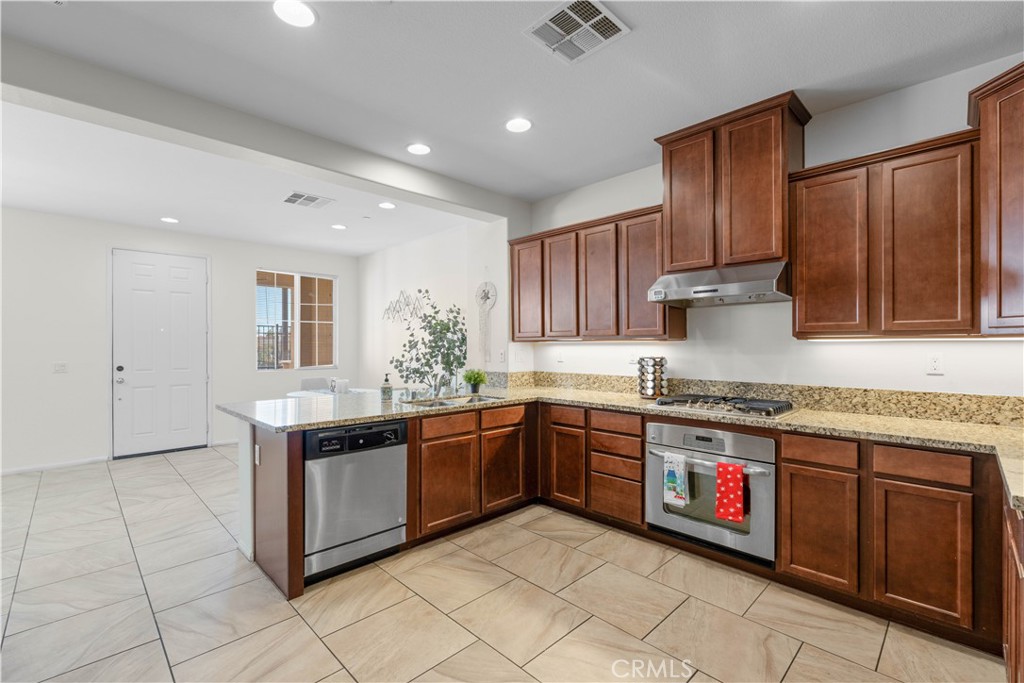 8039 City View Place Rancho Cucamonga, CA 91730 - Photo 7 of 39 a kitchen with stainless steel appliances granite countertop a stove sink and cabinets