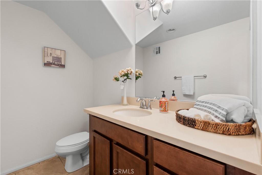 8039 City View Place Rancho Cucamonga, CA 91730 - Photo 9 of 39 a bathroom with a sink a toilet and mirror