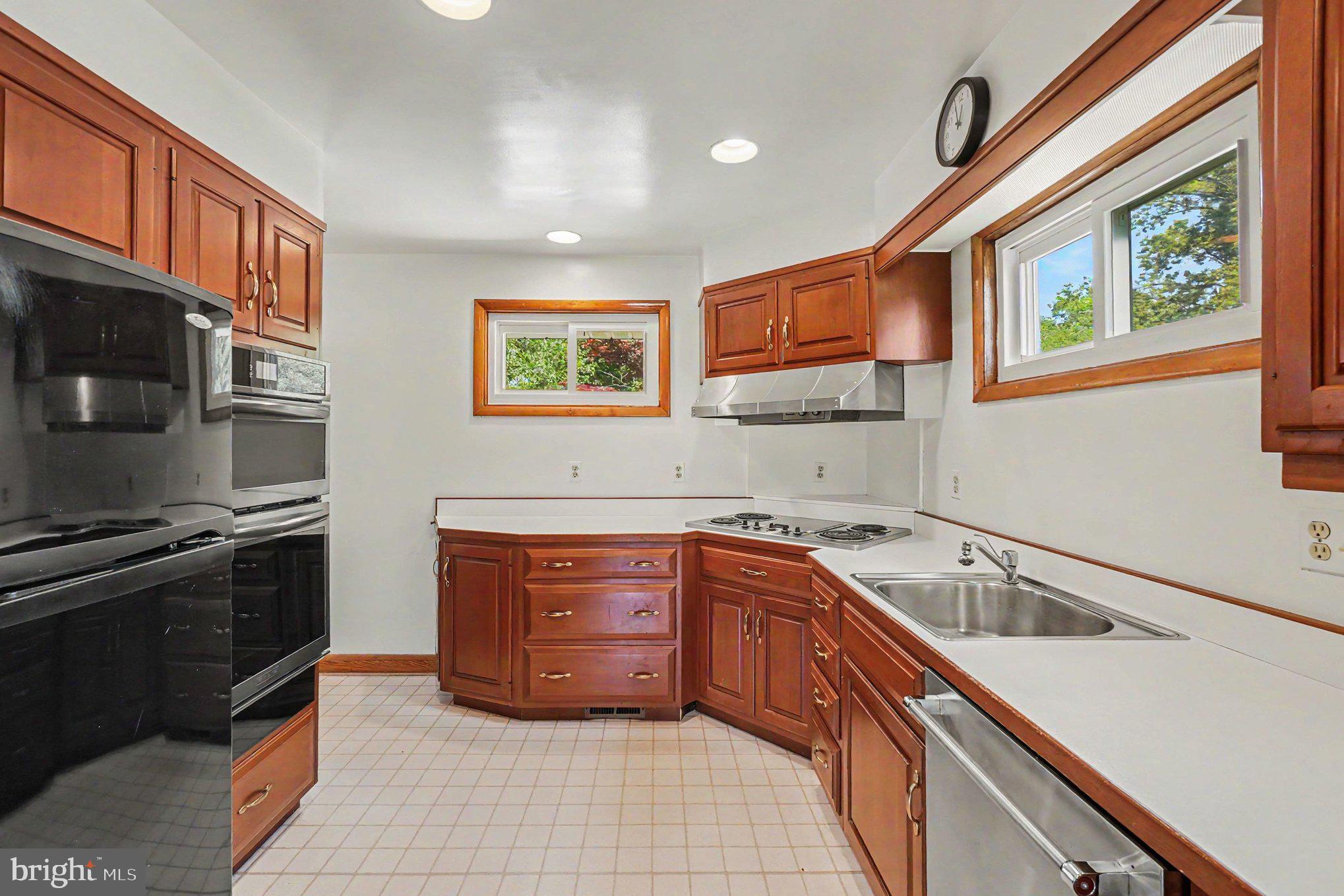 9204 Snyder Lane Perry Hall, MD 21128 - Photo 9 of 42 a kitchen with stainless steel appliances granite countertop a stove a sink and a microwave